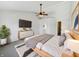Cozy main bedroom with a ceiling fan, accent wall, and en-suite bathroom access at 11063 Deer Valley Dr, Indianapolis, IN 46229