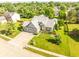Expansive aerial view of the home with manicured landscaping and surrounding greenery at 11229 Echo Ridge Ln, Indianapolis, IN 46236