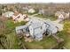 Aerial view of a home's backyard featuring a deck, hot tub, patio, and well-maintained lawn at 11229 Echo Ridge Ln, Indianapolis, IN 46236