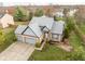 Inviting home with a two-car garage, complemented by a lush green lawn and mature trees at 11229 Echo Ridge Ln, Indianapolis, IN 46236
