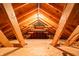 Unfinished attic featuring exposed wood beams with one lightbulb at 11229 Echo Ridge Ln, Indianapolis, IN 46236