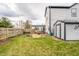 Lush backyard with green grass, a shed, a hot tub, and a wooden fence at 11229 Echo Ridge Ln, Indianapolis, IN 46236