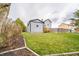 Lush backyard with green grass, garden beds, and fencing with a view of the house at 11229 Echo Ridge Ln, Indianapolis, IN 46236