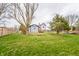 Spacious backyard featuring a well-maintained lawn, mature trees, and partial fencing at 11229 Echo Ridge Ln, Indianapolis, IN 46236