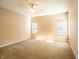 Spacious carpeted bedroom featuring a ceiling fan, and two windows that provide ample natural light at 11229 Echo Ridge Ln, Indianapolis, IN 46236