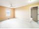 Neutral-toned bedroom with carpet, ceiling fan, and large window for natural light at 11229 Echo Ridge Ln, Indianapolis, IN 46236