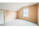Bedroom featuring carpet, a closet, and a large window for natural light at 11229 Echo Ridge Ln, Indianapolis, IN 46236