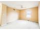 Neutral-toned bedroom with carpet, ceiling fan, and window for natural light at 11229 Echo Ridge Ln, Indianapolis, IN 46236