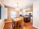 Comfortable dining area with a wooden table set and view into the bright kitchen at 11229 Echo Ridge Ln, Indianapolis, IN 46236