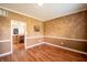 Cozy dining room with wood floors, neutral walls, and an open doorway to the kitchen at 11229 Echo Ridge Ln, Indianapolis, IN 46236
