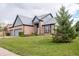 Beautiful home with a two-car garage, complemented by lush green lawn and mature trees at 11229 Echo Ridge Ln, Indianapolis, IN 46236