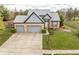 Charming brick home featuring a two-car garage and well-manicured front lawn at 11229 Echo Ridge Ln, Indianapolis, IN 46236