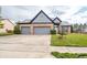A well-maintained home with a two-car garage, beautiful landscaping, and a welcoming entrance at 11229 Echo Ridge Ln, Indianapolis, IN 46236