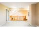 Hallway featuring carpet, wooden railings, and a view of a room with skylights at 11229 Echo Ridge Ln, Indianapolis, IN 46236