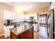 Well-lit kitchen featuring white cabinets, stainless steel appliances, and a wooden island at 11229 Echo Ridge Ln, Indianapolis, IN 46236