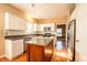 Modern kitchen showcases stainless appliances, white cabinets, and center wooden island at 11229 Echo Ridge Ln, Indianapolis, IN 46236