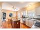 Bright eat-in kitchen with white cabinets, stainless steel appliances, and a center island at 11229 Echo Ridge Ln, Indianapolis, IN 46236