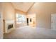 Bright living room with a fireplace, large windows, vaulted ceilings, and neutral carpet at 11229 Echo Ridge Ln, Indianapolis, IN 46236