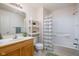 Bathroom featuring a shower, vanity, storage shelves, and ample lighting at 11475 Clay Ct # 102, Fishers, IN 46037