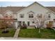 Attractive townhome featuring a landscaped front yard, bright siding, and inviting curb appeal at 11475 Clay Ct # 102, Fishers, IN 46037