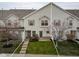 Charming townhome with a well-manicured lawn, inviting entryway, and classic architectural details at 11475 Clay Ct # 102, Fishers, IN 46037