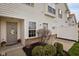 View of the front door, with landscaping and a small outdoor area at 11475 Clay Ct # 102, Fishers, IN 46037