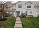 Charming two-story townhouse with neat landscaping, inviting entrance, and a well-maintained lawn at 11475 Clay Ct # 102, Fishers, IN 46037