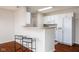 Eat-in kitchen featuring modern appliances, a breakfast bar, and two stools at 11475 Clay Ct # 102, Fishers, IN 46037