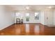 Bright, spacious living room featuring gleaming hardwood floors and a door to the outside at 11475 Clay Ct # 102, Fishers, IN 46037