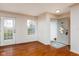 Bright living room with hardwood floors, a glass paneled door and a neutrally painted interior at 11475 Clay Ct # 102, Fishers, IN 46037