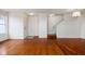 Open-concept living room with hardwood floors and staircase at 11475 Clay Ct # 102, Fishers, IN 46037