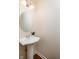 Charming powder room with a pedestal sink, mirror, and modern light fixture at 11475 Clay Ct # 102, Fishers, IN 46037