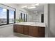 A bathroom showcasing a double vanity, a modern vessel sink, and a large window with a view at 11941 Sand Dollar Cir, Indianapolis, IN 46256