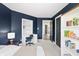 Bedroom featuring blue walls, built-in shelving and a desk at 11941 Sand Dollar Cir, Indianapolis, IN 46256