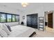 Cozy bedroom with black frame window, closet and adjacent doorway at 11941 Sand Dollar Cir, Indianapolis, IN 46256