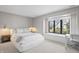 A serene bedroom with a comfortable bed, a window seat, and natural light at 11941 Sand Dollar Cir, Indianapolis, IN 46256