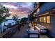 Spacious outdoor deck showcasing stylish furniture and a beautiful view of the serene lake and sunset at 11941 Sand Dollar Cir, Indianapolis, IN 46256