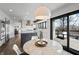 Open-concept dining area with access to deck and featuring modern lighting and stainless steel appliances at 11941 Sand Dollar Cir, Indianapolis, IN 46256