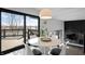 Dining area featuring modern lighting, deck access, and views of the lake at 11941 Sand Dollar Cir, Indianapolis, IN 46256