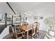 Elegant dining room with wood floors, a rustic wooden table, stylish lighting, and white walls at 11941 Sand Dollar Cir, Indianapolis, IN 46256