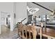 Dining area featuring modern lighting, a rustic table set, and open access to other living spaces at 11941 Sand Dollar Cir, Indianapolis, IN 46256