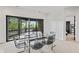 Bright dining area with sleek furniture and sliding glass doors opening to a scenic view at 11941 Sand Dollar Cir, Indianapolis, IN 46256