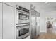 Close up of kitchen appliances including a double oven and stainless steel refrigerator at 11941 Sand Dollar Cir, Indianapolis, IN 46256