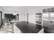 Modern kitchen boasts stainless steel appliances, double ovens, and large center island with stone countertop at 11941 Sand Dollar Cir, Indianapolis, IN 46256