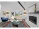 Comfortable living room showcases large windows, fireplace, hardwood floors, and stylish furniture at 11941 Sand Dollar Cir, Indianapolis, IN 46256