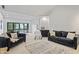 Open-concept living room with wet bar, dining area, and sliding doors to outdoor space at 11941 Sand Dollar Cir, Indianapolis, IN 46256