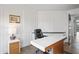 Well-lit office featuring a modern desk, comfortable chair, and custom wall paneling at 11941 Sand Dollar Cir, Indianapolis, IN 46256
