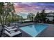 Relaxing backyard with a sparkling pool, poolside lounge chairs, and scenic views of the adjacent lake at 11941 Sand Dollar Cir, Indianapolis, IN 46256