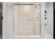 A glass-enclosed shower with a built-in niche, modern fixtures, and a sleek design at 11941 Sand Dollar Cir, Indianapolis, IN 46256