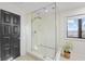 A glass-enclosed shower with a rainfall showerhead, a built-in niche, and modern fixtures at 11941 Sand Dollar Cir, Indianapolis, IN 46256